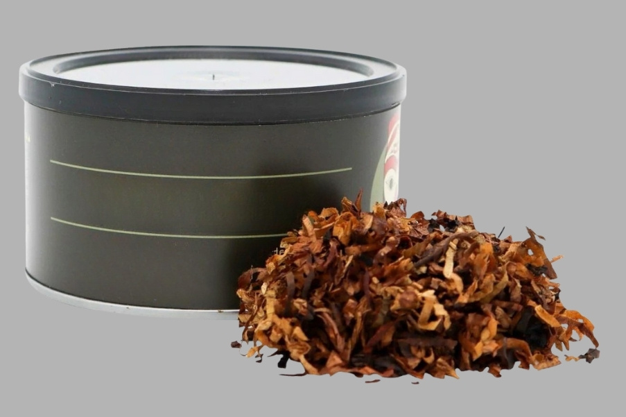 A tin of pipe tobacco with a pile of loose-cut tobacco placed in front on a gray background.